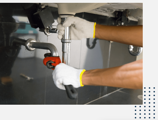 technician installing pipe under a sink